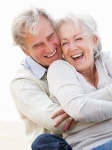 Happy elderly couple embracing and smiling together
