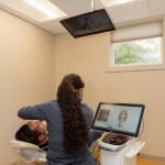 Dental office reception area with staff member working at computer workstation in modern facility