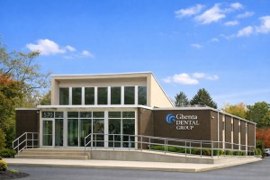 Modern medical office building exterior with contemporary stone and glass architecture under blue sky